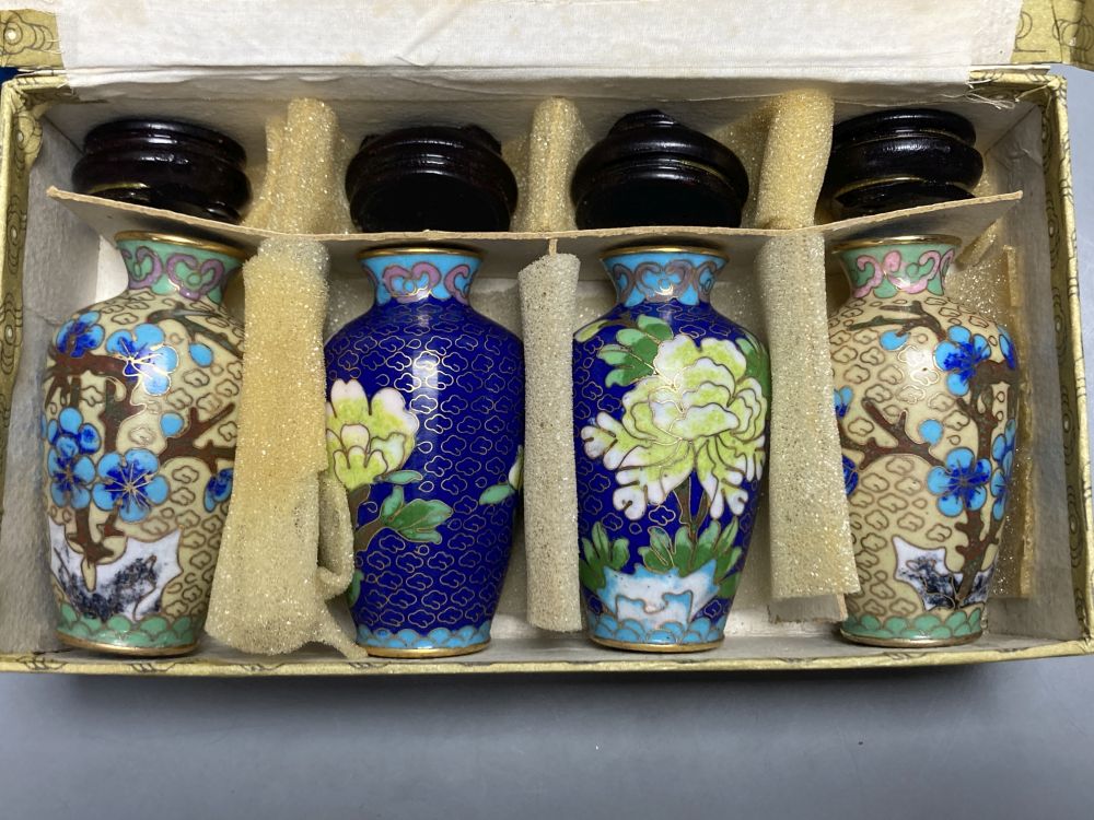 A group of Chinese wood stands and cloisonne enamel vases